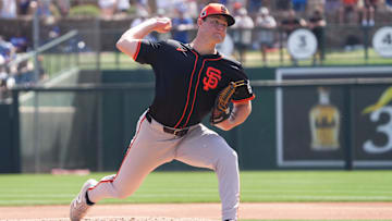 Mar 1, 2025; Phoenix, Arizona, USA; San Francisco Giants pitcher Carson Seymour (77) pitches against the Los Angeles Dodgers during the first inning at Camelback Ranch-Glendale. 