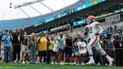 Aug 8, 2025; Charlotte, North Carolina, USA; Cleveland Browns quarterback Shedeur Sanders (12) runs on to the field before the game at Bank of America Stadium. Mandatory Credit: Bob Donnan-Imagn Images