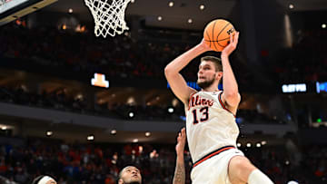 Mar 21, 2025; Milwaukee, WI, USA: Illinois Fighting Illini center Tomislav Ivisic (13) drives to the hoop past Xavier Musketeers guard Dayvion McKnight (20) during the first half at Fiserv Forum. Mandatory Credit: Benny Sieu-Imagn Images