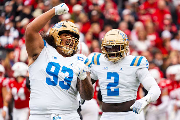 UCLA defensive lineman Jay Toia and linebacker Oluwafemi Oladejo celebrate after a sack against the Nebraska Cornhuskers.