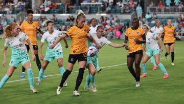 Jun 28, 2024; Kansas City, Missouri, USA; Houston Dash midfielder Sophie Schmidt (13) battles Kansas City Current defender Isabel Rodriguez (18) for the ball in the second half at CPKC Stadium. Mandatory Credit: William Purnell-USA TODAY Sports