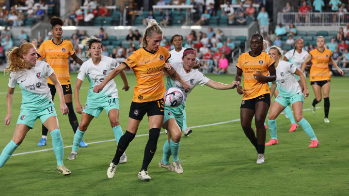 Jun 28, 2024; Kansas City, Missouri, USA; Houston Dash midfielder Sophie Schmidt (13) battles Kansas City Current defender Isabel Rodriguez (18) for the ball in the second half at CPKC Stadium. Mandatory Credit: William Purnell-USA TODAY Sports