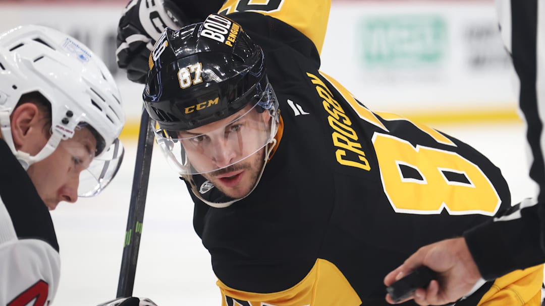 Mar 15, 2025; Pittsburgh, Pennsylvania, USA;  Pittsburgh Penguins center Sidney Crosby (87) watches for the puck drop on a face-off against the New Jersey Devils during the third period at PPG Paints Arena.