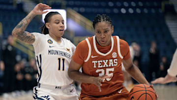 Dec 1, 2024; Estero, FL, USA; University of Texas Madison Booker (35) dribbles the ball while defended by West Virginia University Sydney Shaw (11) in the fourth quarter during the Women's Gulf Coast Showcase at Hertz Arena. Mandatory Credit: Chris Tilley-Imagn Images
