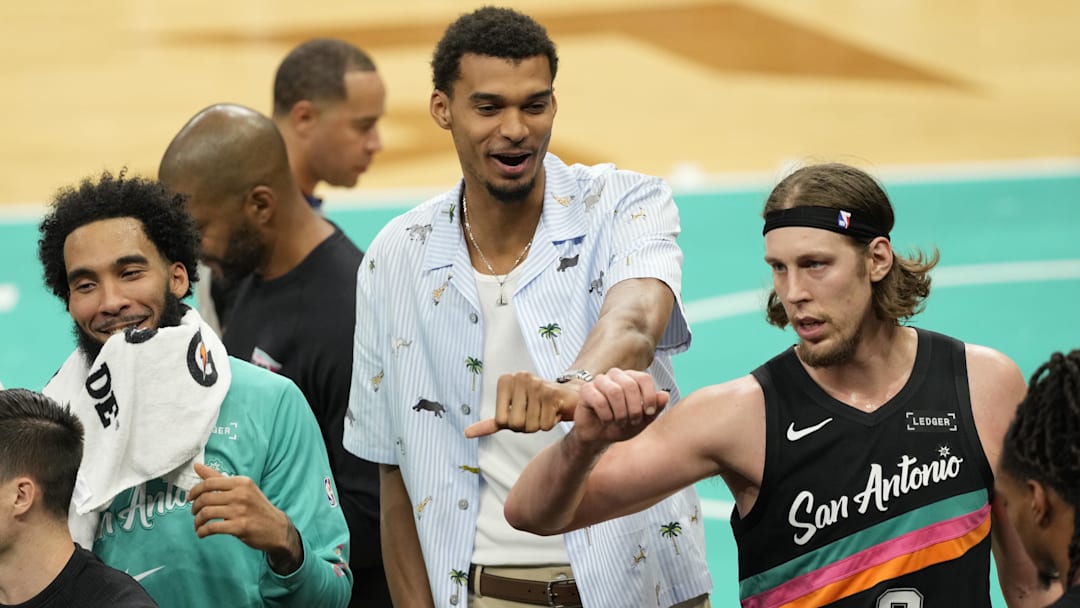 Nov 20, 2025; San Antonio, Texas, USA; San Antonio Spurs forward Victor Wembanyama (1) with teammates forwards Julian Champagnie (30) and Kelly Olynyk (8) during a time out in the first half against the Atlanta Hawks at Frost Bank Center. Mandatory Credit: Scott Wachter-Imagn Images