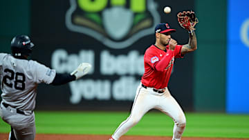 Oct 19, 2024; Cleveland, Ohio, USA; Cleveland Guardians shortstop Brayan Rocchio (4) commits an error trying to turn a double play over New York Yankees catcher Austin Wells (28) during the tenth inning during game five of the ALCS for the 2024 MLB playoffs at Progressive Field. Mandatory Credit: David Dermer-Imagn Images