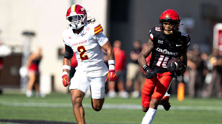 Cincinnati Bearcats wide receiver Caleb Goodie (10) catches a pass and runs for a touchdown as Iowa State Cyclones defensive back Jamison Patton (2) defends in the fourth quarter of the NCAA football game between the Cincinnati Bearcats and Iowa State Cyclones at Nippert Stadium in Cincinnati on Oct. 4, 2025.