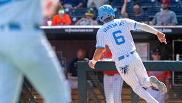 Jun 14, 2024; Omaha, NE, USA; North Carolina Tar Heels infielder Jackson Van De Brake (6) scores on a walk off RBI single by North Carolina Tar Heels center fielder Vance Honeycutt (7) during the ninth inning against the Virginia Cavaliers at Charles Schwab Filed Omaha. Mandatory Credit: Dylan Widger-Imagn Images
