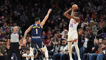 Dec 25, 2024; Phoenix, Arizona, USA; Phoenix Suns forward Kevin Durant (35) shoots over Denver Nuggets forward Michael Porter Jr. (1) during the second half at Footprint Center. Mandatory Credit: Joe Camporeale-Imagn Images