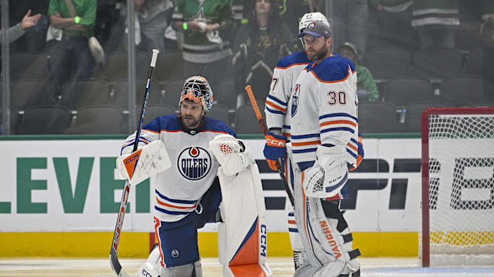 May 23, 2024; Dallas, Texas, USA; Edmonton Oilers goaltender Stuart Skinner (74) and goaltender Calvin Pickard (30) look on a center Connor McDavid (not pictured) is checked by the referees during the second overtime period against the Dallas Stars in game one of the Western Conference Final of the 2024 Stanley Cup Playoffs at American Airlines Center. Mandatory Credit: Jerome Miron-Imagn Images