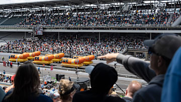 Fans watch the Wienermobiles on Carb Day ahead of the Indianapolis 500 at Indianapolis Motor Speedway