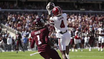 Nov 15, 2025; College Station, Texas, USA; South Carolina Gamecocks defensive back Vicari Swain (4) intercepts a pass intended for Texas A&M Aggies wide receiver Mario Craver (1) in the end zone during the second quarter at Kyle Field. Mandatory Credit: Troy Taormina-Imagn Images
