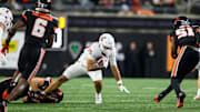 Nov 23, 2024; Corvallis, Oregon, USA; Washington State Cougars running back Leo Pulalasi (20) is stopped for a short gain during the third quarter against the Oregon State Beavers at Reser Stadium. Mandatory Credit: Craig Strobeck-Imagn Images