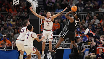 Mar 21, 2025; Milwaukee, WI, USA: Xavier Musketeers guard Ryan Conwell (7) shoots a layup past Illinois Fighting Illini guard Dra Gibbs-Lawhorn (2) during the first half at Fiserv Forum. Mandatory Credit: Jeff Hanisch-Imagn Images