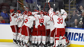 Mar 29, 2025; Toledo, OH, USA;  Boston University forward Quinn Hutson (17) receives congratulations from teammates after scoring the winning goal in overtime against the Cornell at Huntington Center. Mandatory Credit: Rick Osentoski-Imagn Images