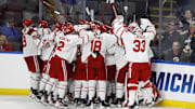 Mar 29, 2025; Toledo, OH, USA;  Boston University forward Quinn Hutson (17) receives congratulations from teammates after scoring the winning goal in overtime against the Cornell at Huntington Center. Mandatory Credit: Rick Osentoski-Imagn Images