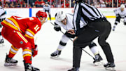 Nov 11, 2024; Calgary, Alberta, CAN; Los Angeles Kings center Anze Kopitar (11) and Calgary Flames center Mikael Backlund (11) face off for the puck during the third period at Scotiabank Saddledome. Mandatory Credit: Sergei Belski-Imagn Images
