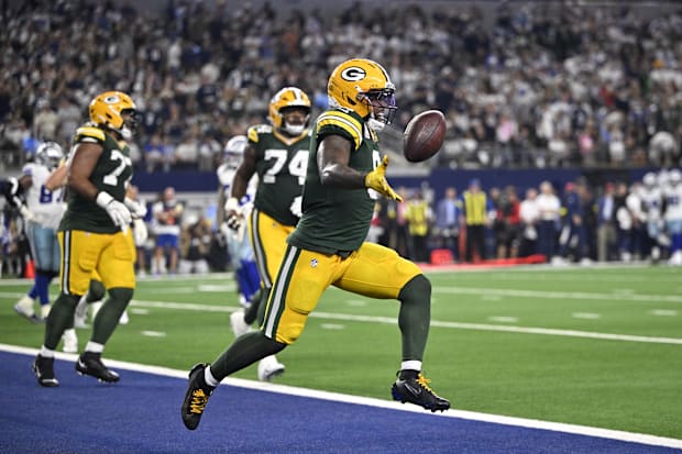 Green Bay Packers running back Josh Jacobs (8) celebrates after a touchdown against the Dallas Cowboys.