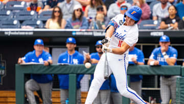 Jun 19, 2024; Omaha, NE, USA; Florida Gators shortstop Colby Shelton (10) hits a RBI double against the Kentucky Wildcats during the first inning at Charles Schwab Field Omaha. Mandatory Credit: Dylan Widger-Imagn Images
