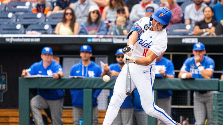 Jun 19, 2024; Omaha, NE, USA; Florida Gators shortstop Colby Shelton (10) hits a RBI double against the Kentucky Wildcats during the first inning at Charles Schwab Field Omaha. Mandatory Credit: Dylan Widger-Imagn Images