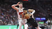 Milwaukee Bucks forward Giannis Antetokounmpo drives with the ball as Houston Rockets center Alperen Sengun defends.