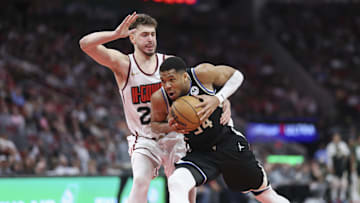 Milwaukee Bucks forward Giannis Antetokounmpo drives with the ball as Houston Rockets center Alperen Sengun defends.