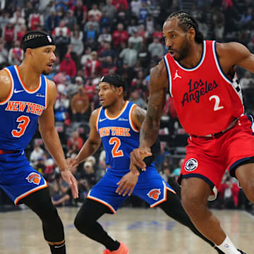 Mar 7, 2025; Inglewood, California, USA; LA Clippers forward Kawhi Leonard (2) dribbles the ball against New York Knicks guard Miles McBride (2) and guard Josh Hart (3) in the first half at Intuit Dome. Mandatory Credit: Kirby Lee-Imagn Images
