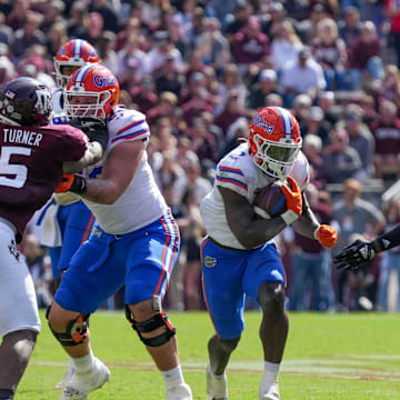 Nov 5, 2022; College Station, Texas, USA; Florida Gators running back Montrell Johnson Jr. (2) runs the ball between Texas A&M Aggies defensive lineman Shemar Turner (5) and linebacker Edgerrin Cooper (45) in the second half at Kyle Field. Mandatory Credit: Daniel Dunn-Imagn Images