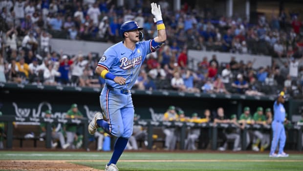 Texas Rangers slugger Josh Jung waves his walk-off home run over the fence.