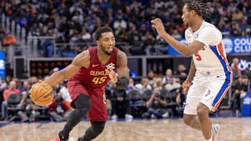 Oct 27, 2025; Detroit, Michigan, USA; Detroit Pistons forward Ronald Holland II (5) defends against Cleveland Cavaliers guard Donovan Mitchell (45) during the second half at Little Caesars Arena. Mandatory Credit: David Reginek-Imagn Images
