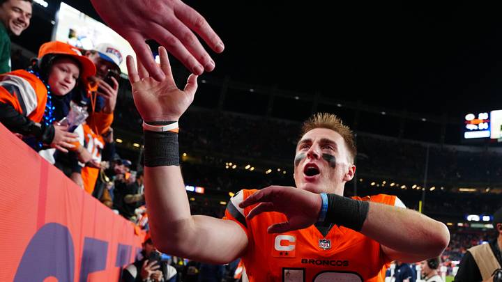 Dec 14, 2025; Denver, Colorado, USA; Denver Broncos quarterback Bo Nix (10) high-fives fans after defeating the Green Bay Packers at Empower Field at Mile High. Mandatory Credit: Ron Chenoy-Imagn Images
