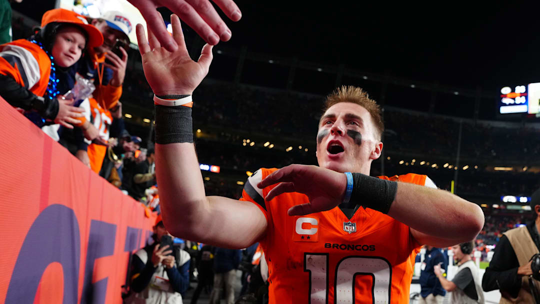 Dec 14, 2025; Denver, Colorado, USA; Denver Broncos quarterback Bo Nix (10) high-fives fans after defeating the Green Bay Packers at Empower Field at Mile High. 
