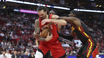 Mar 25, 2025; Houston, Texas, USA; Houston Rockets center Steven Adams (12) attempts to control the ball as Atlanta Hawks guard Caris LeVert (3) defends during the second quarter at Toyota Center. Mandatory Credit: Troy Taormina-Imagn Images