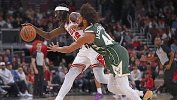 Oct 12, 2025; Chicago, Illinois, USA;  Chicago Bulls forward Mouhamadou Gueye (16) and Milwaukee Bucks guard Andre Jackson Jr. (44) chase a loose ball during the second half at the United Center. Mandatory Credit: Matt Marton-Imagn Images
