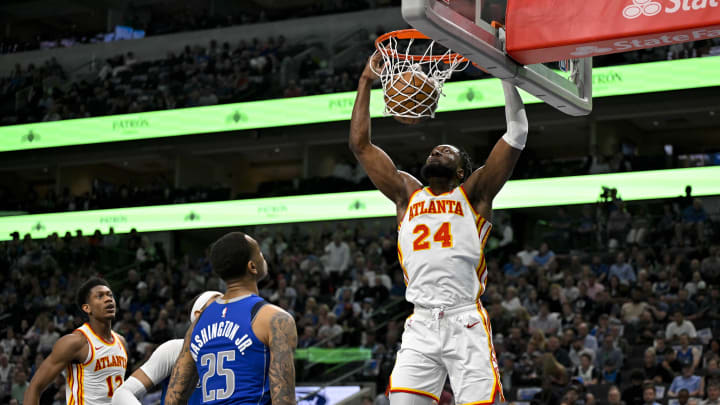 Apr 4, 2024; Dallas, Texas, USA; Atlanta Hawks forward Bruno Fernando (24) dunks the ball as Dallas Mavericks forward P.J. Washington (25) looks on during the first half at the American Airlines Center. Mandatory Credit: Jerome Miron-USA TODAY Sports