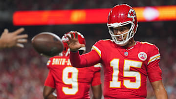 Sep 5, 2024; Kansas City, Missouri, USA; Kansas City Chiefs starting quarterback Patrick Mahomes (15) retrieves a touchdown ball belonging to wide receiver Xavier Worthy (not pictured) during the second half against the Baltimore Ravens at GEHA Field at Arrowhead Stadium. Mandatory Credit: Jay Biggerstaff-Imagn Images