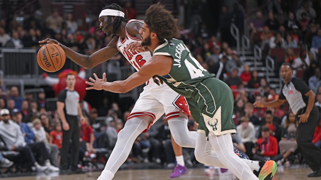 Oct 12, 2025; Chicago, Illinois, USA;  Chicago Bulls forward Mouhamadou Gueye (16) and Milwaukee Bucks guard Andre Jackson Jr. (44) chase a loose ball