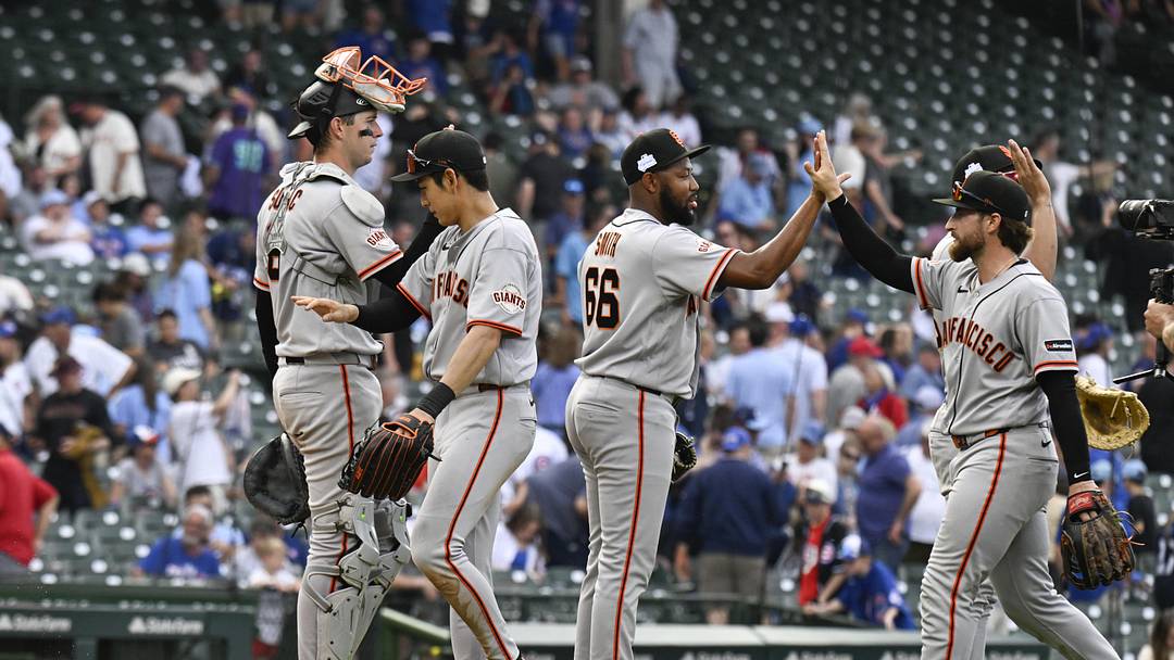 San Francisco Giants players high five after the game against the Chicago Cubs at Wrigley Field. San Francisco Giants players high five after the game against the Chicago Cubs at Wrigley Field.