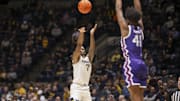 Feb 25, 2025; Morgantown, West Virginia, USA; West Virginia Mountaineers guard Javon Small (7) shoots over TCU Horned Frogs guard Jace Posey (41) during the first half at WVU Coliseum. Mandatory Credit: Ben Queen-Imagn Images