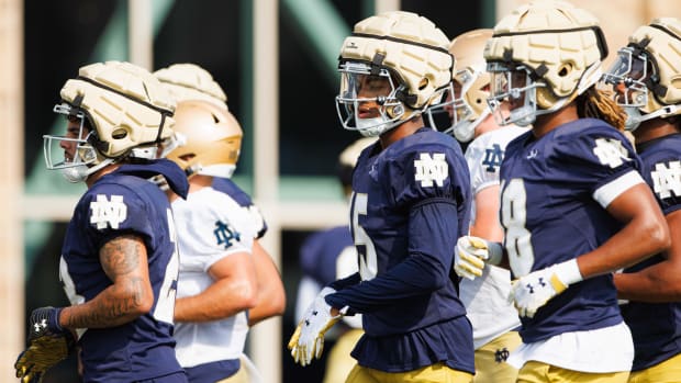 Notre Dame's Leonard Moore heads to the next drill at fall camp's opening practice.