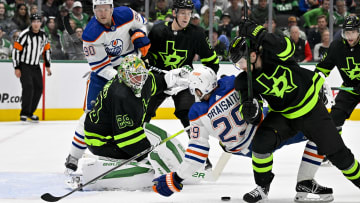 Dallas Stars goaltender Jake Oettinger (29) and defenseman Nils Lundkvist (5) and center Sam Steel (18) and Edmonton Oilers right wing Corey Perry (90) and center Leon Draisaitl (29) look for the puck.