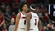 Nov 11, 2025; Louisville, Kentucky, USA;  Louisville Cardinals guard Mikel Brown Jr. (0) and guard Ryan Conwell (3) celebrate during the first half against the Kentucky Wildcats at KFC Yum! Center. Mandatory Credit: Jamie Rhodes-Imagn Images