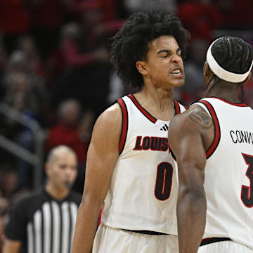 Nov 11, 2025; Louisville, Kentucky, USA;  Louisville Cardinals guard Mikel Brown Jr. (0) and guard Ryan Conwell (3) celebrate during the first half against the Kentucky Wildcats at KFC Yum! Center. Mandatory Credit: Jamie Rhodes-Imagn Images