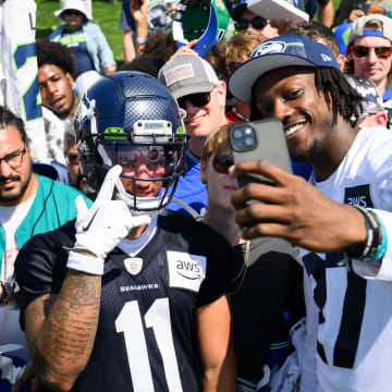 Jul 30, 2023; Renton, WA, USA; Seattle Seahawks wide receiver Jaxon Smith-Njigba (11) and cornerback Riq Woolen (27) take a selfie with fans after practice at the Virginia Mason Athletic Center. Mandatory Credit: Steven Bisig-USA TODAY Sports
