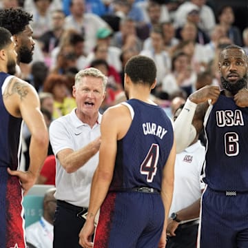 Aug 6, 2024; Paris, France; United States head coach Steve Kerr talks to centre Joel Embiid (11) and small forward Jayson Tatum (10) and shooting guard Stephen Curry (4) and guard LeBron James (6) in the first half against Brazil in a men’s basketball quarterfinal game during the Paris 2024 Olympic Summer Games at Accor Arena. Mandatory Credit: Kyle Terada-Imagn Images