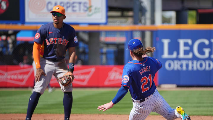 Feb 25, 2024; Port St. Lucie, Florida, USA;  New York Mets outfielder Ben Gamel (21) steals second base in the second inning as Houston Astros shortstop Dixon Machado (26) looks on at Clover Park. Mandatory Credit: Jim Rassol-USA TODAY Sports