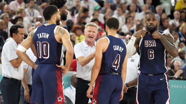 Aug 6, 2024; Paris, France; United States head coach Steve Kerr talks to centre Joel Embiid (11) and small forward Jayson Tatum (10) and shooting guard Stephen Curry (4) and guard LeBron James (6) in the first half against Brazil in a men’s basketball quarterfinal game during the Paris 2024 Olympic Summer Games at Accor Arena. Mandatory Credit: Kyle Terada-USA TODAY Sports