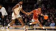 Feb 8, 2025; Nashville, Tennessee, USA;  Texas Longhorns guard Julian Larry (1) dribbles past Vanderbilt Commodores forward Jaylen Carey (22) during the second half at Memorial Gymnasium. Mandatory Credit: Steve Roberts-Imagn Images