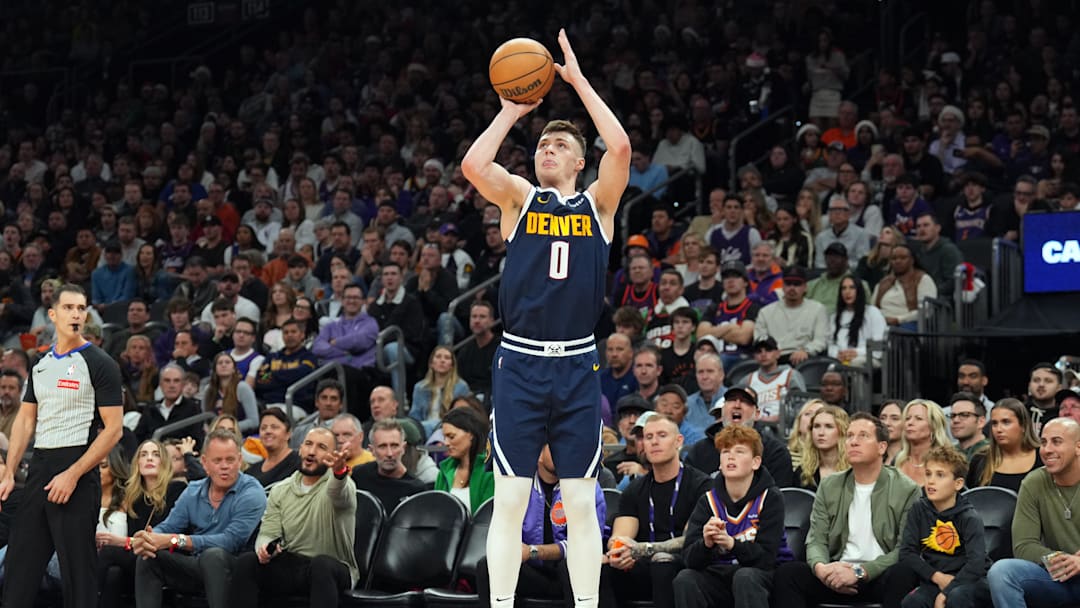 Dec 25, 2024; Phoenix, Arizona, USA; Denver Nuggets guard Christian Braun (0) shoots against the Phoenix Suns during the second half at Footprint Center. Mandatory Credit: Joe Camporeale-Imagn Images