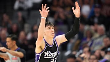 Mar 22, 2025; Sacramento, California, USA; Sacramento Kings forward Jake LaRavia (33) gestures after making a three point basket against the Milwaukee Bucks during the second quarter at Golden 1 Center. Mandatory Credit: Darren Yamashita-Imagn Images
